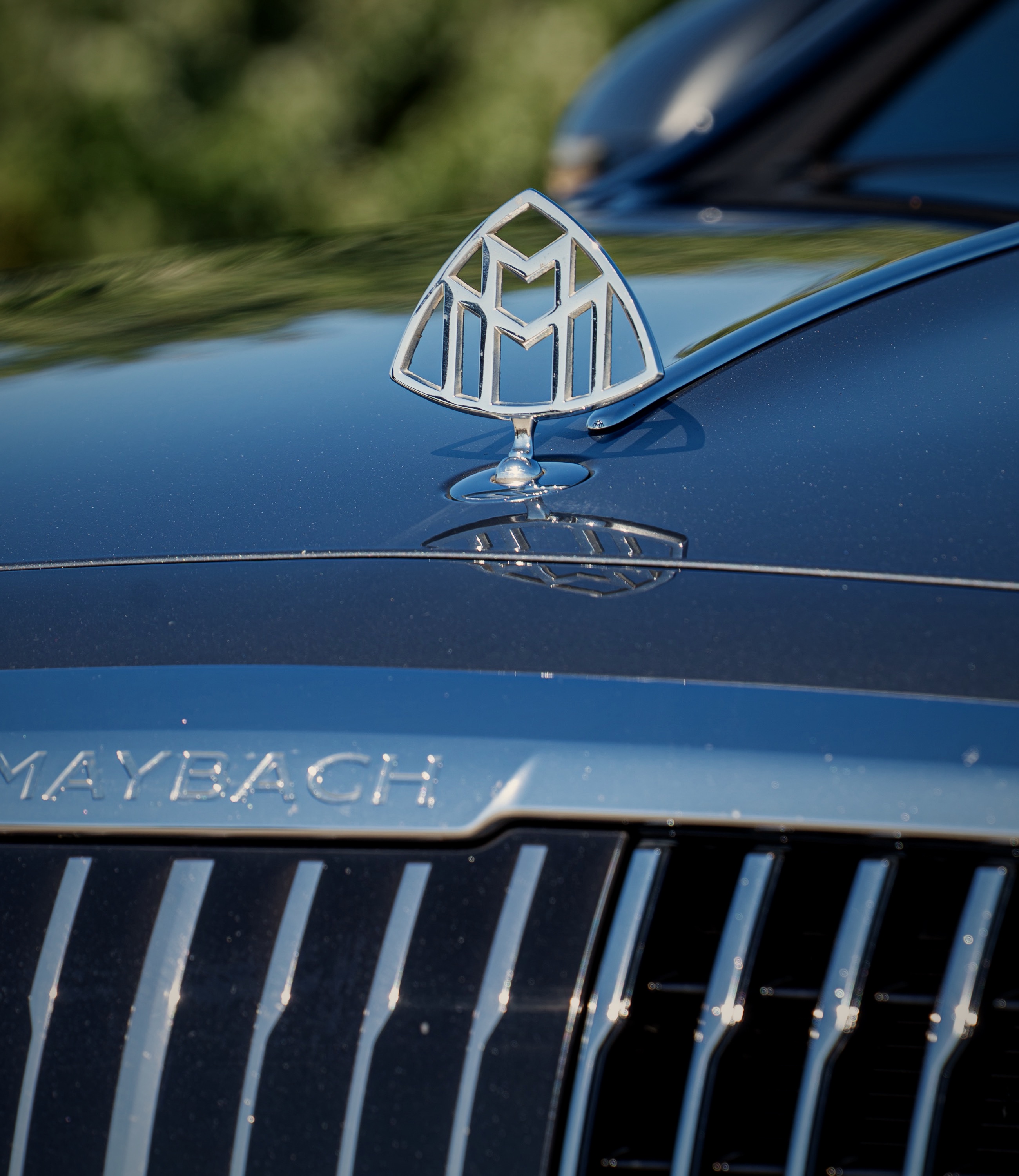 Maybach hood ornament above a chrome grille